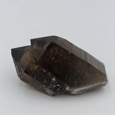 Natural smoky quartz - double crystal, overgrown with tourmalines, albite. A very interesting aesthetic collector's piece.